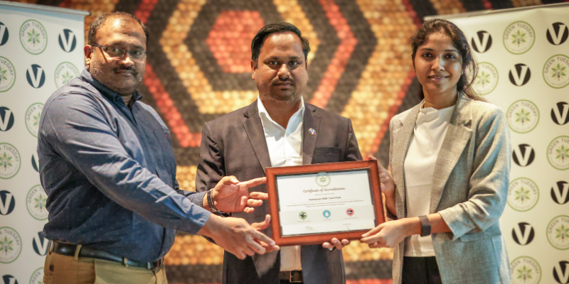Prem Reddy and Santosh Dutta from Vamsiram Group, alongside Bhavya Vatrapu from the Green Tuesday Initiative, hold an accreditation certificate at the ceremony marking Vamsiram BSR Tech Park’s commitment to serving sustainable meals every Tuesday.